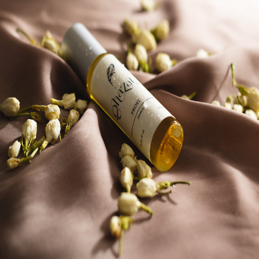 Photo of our perfume bottle Frost in a brown silk cloth and jasmine background